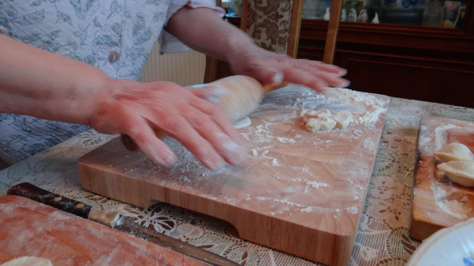 Hands kneading dough in class